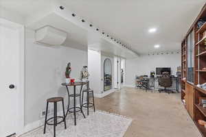 Office area featuring concrete flooring and baseboards
