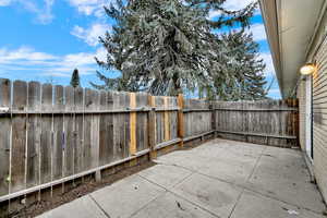 Fenced backyard featuring a patio