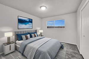 Bedroom featuring carpet floors and baseboards