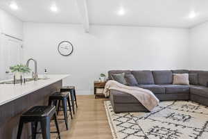 Living area with recessed lighting and light wood finished floors