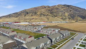 Aerial view of property's location with nearby suburban area and a mountain backdrop