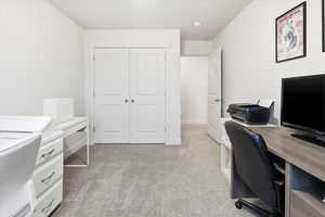 Office space with light carpet and baseboards