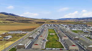 Aerial perspective of suburban area featuring a mountain backdrop