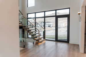 Entryway with light wood-style floors and stairway