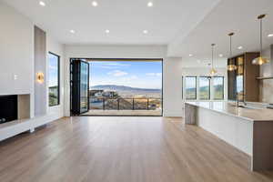 Main floor living room with a mountain view, recessed lighting, and light wood finished floors
