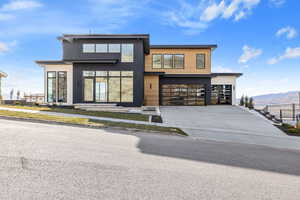 Contemporary house featuring driveway, a mountain view, and a garage