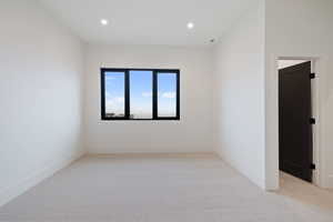 Bedroom featuring light colored carpet and recessed lighting