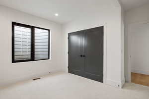 Bedroom featuring carpet floors, a closet, and recessed lighting