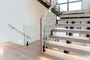 Staircase featuring wood finished floors