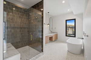 Primary Full bath with a freestanding bath, double vanity, a shower stall, light tile patterned flooring, and recessed lighting