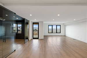 Basement Living room featuring light wood-style flooring and recessed lighting