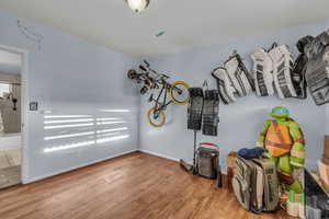 Bedroom with wood finished floors .