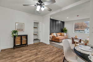 Living room with wood finished floors, ceiling fan, and recessed lighting