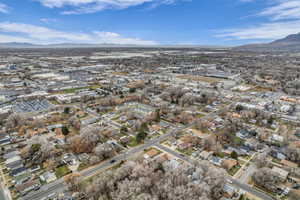 Aerial view of property's location with a mountain backdrop and nearby suburban area