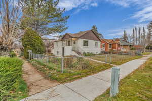 View of front facade featuring a fenced front yard and a gate