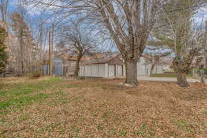View of yard with an outdoor structure and a garage
