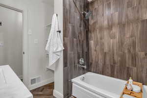 Bathroom featuring washtub / shower combination and vanity