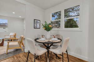 Dining room with healthy amount of natural light, wood finished floors, and recessed lighting