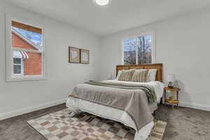 Carpeted bedroom with multiple windows