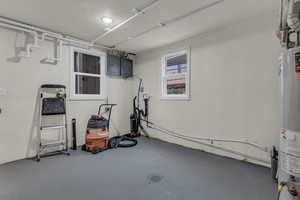Basement with electric panel and water heater
