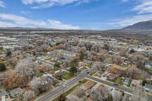 Aerial overview of property's location with a mountainous background and nearby suburban area