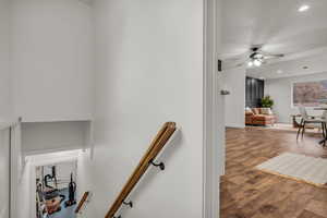 Stairs with recessed lighting, wood finished floors, and ceiling fan