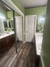 Bathroom with double vanity and second closet