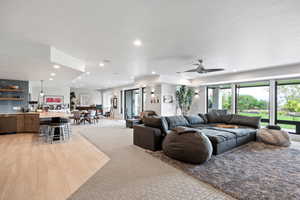 Living room with recessed lighting, light wood-type flooring, and ceiling fan