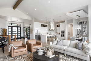 Living room featuring beamed ceiling, light wood-style flooring, high vaulted ceiling, and recessed lighting