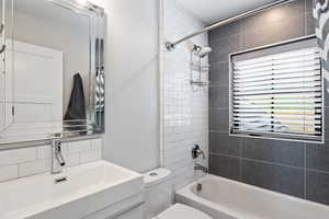 Full bath with tub / shower combination, backsplash, and vanity