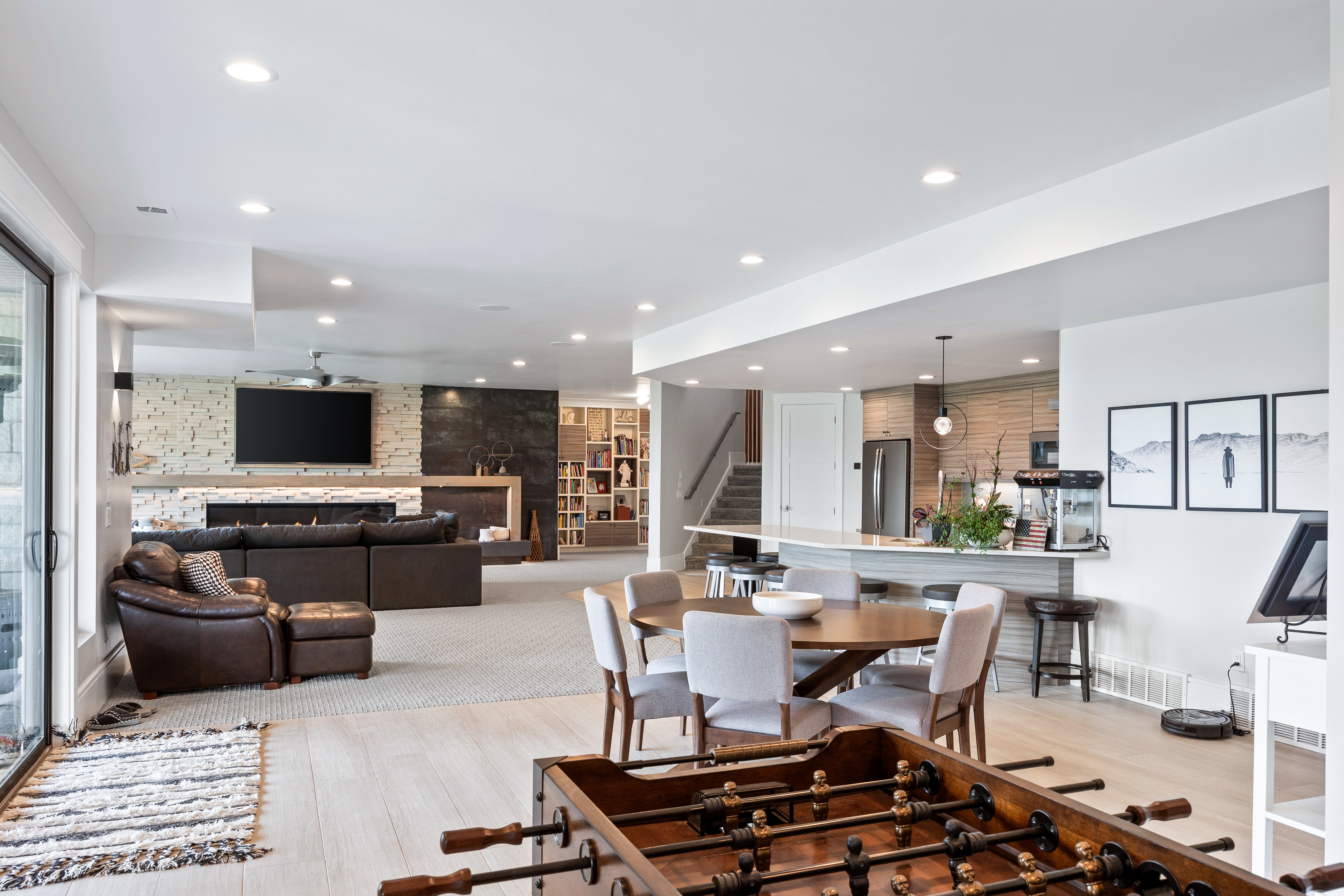 Dining room featuring stairway, recessed lighting, an accent wall, and light wood finished floors