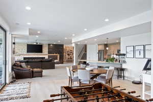 Dining room featuring stairway, recessed lighting, an accent wall, and light wood finished floors