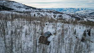 Snowy aerial view featuring a mountain view