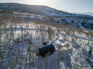 Snowy aerial view featuring a mountain view