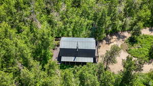 View of subject property featuring a heavily wooded area
