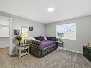 Living area with light colored carpet and baseboards