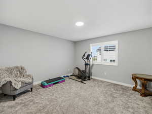 Exercise area featuring baseboards and carpet