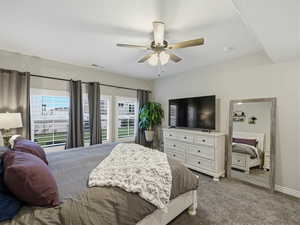 Bedroom featuring dark carpet and ceiling fan