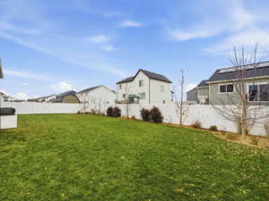 Fenced backyard with a residential view