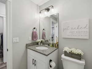 Half bathroom with vanity and toilet