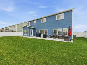 Rear view of property with a fenced backyard, stucco siding, a patio, and outdoor lounge area