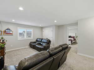 Carpeted living area featuring recessed lighting