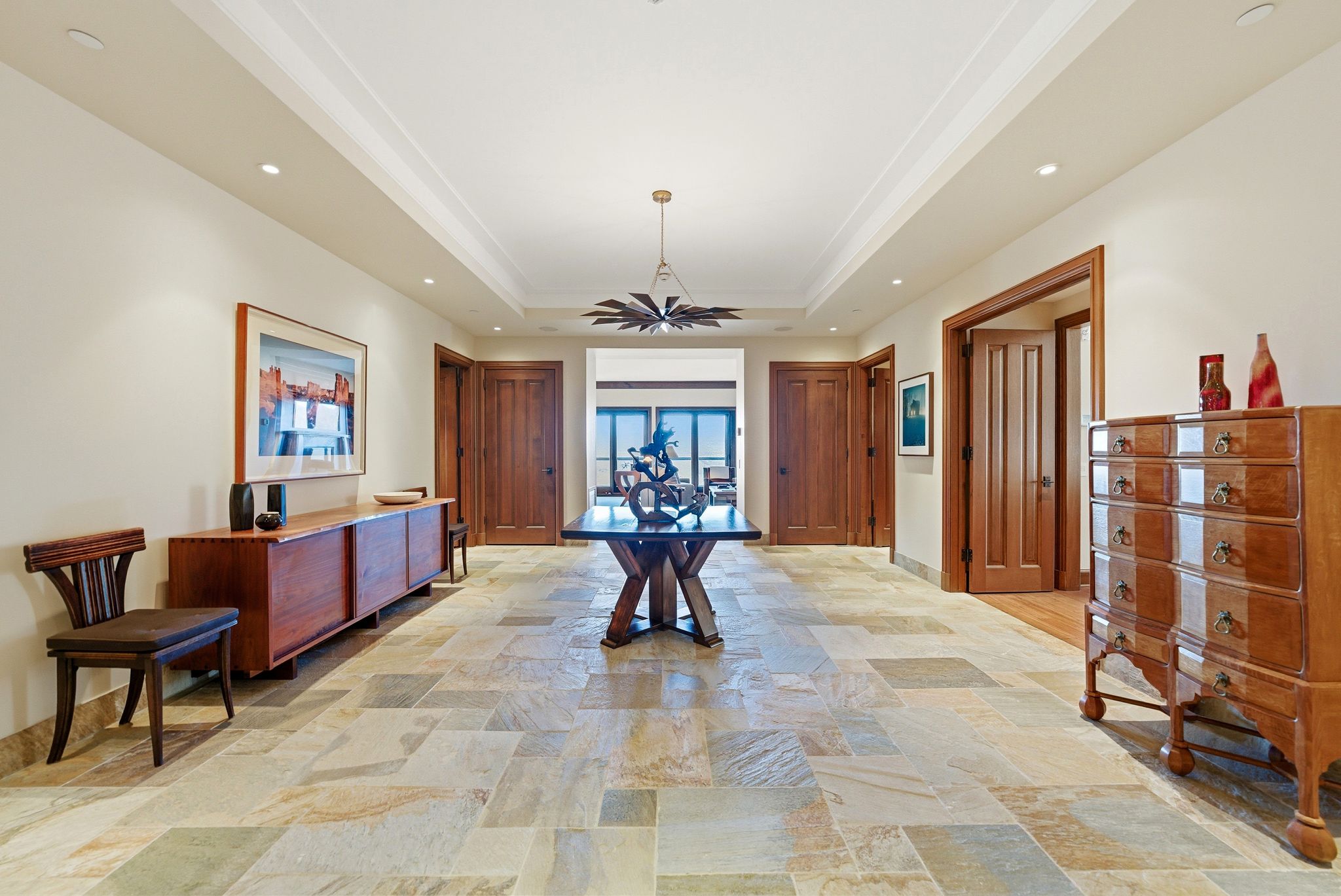 Dining space featuring recessed lighting, stone tile floors, and a tray ceiling