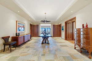 Dining space featuring recessed lighting, stone tile floors, and a tray ceiling