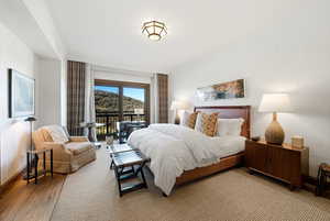 Bedroom featuring access to exterior and baseboards