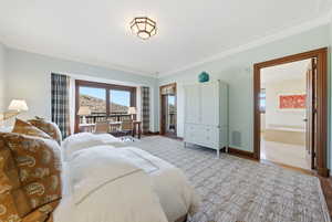 Bedroom featuring access to exterior and crown molding