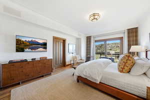 Bedroom with dark wood-type flooring and access to exterior