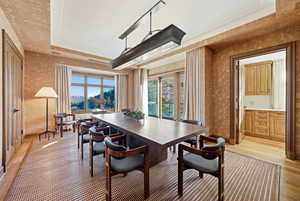 Dining area featuring light wood-style floors and wallpapered walls