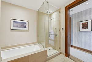 Bathroom featuring a garden tub, a stall shower, tile patterned floors, and recessed lighting