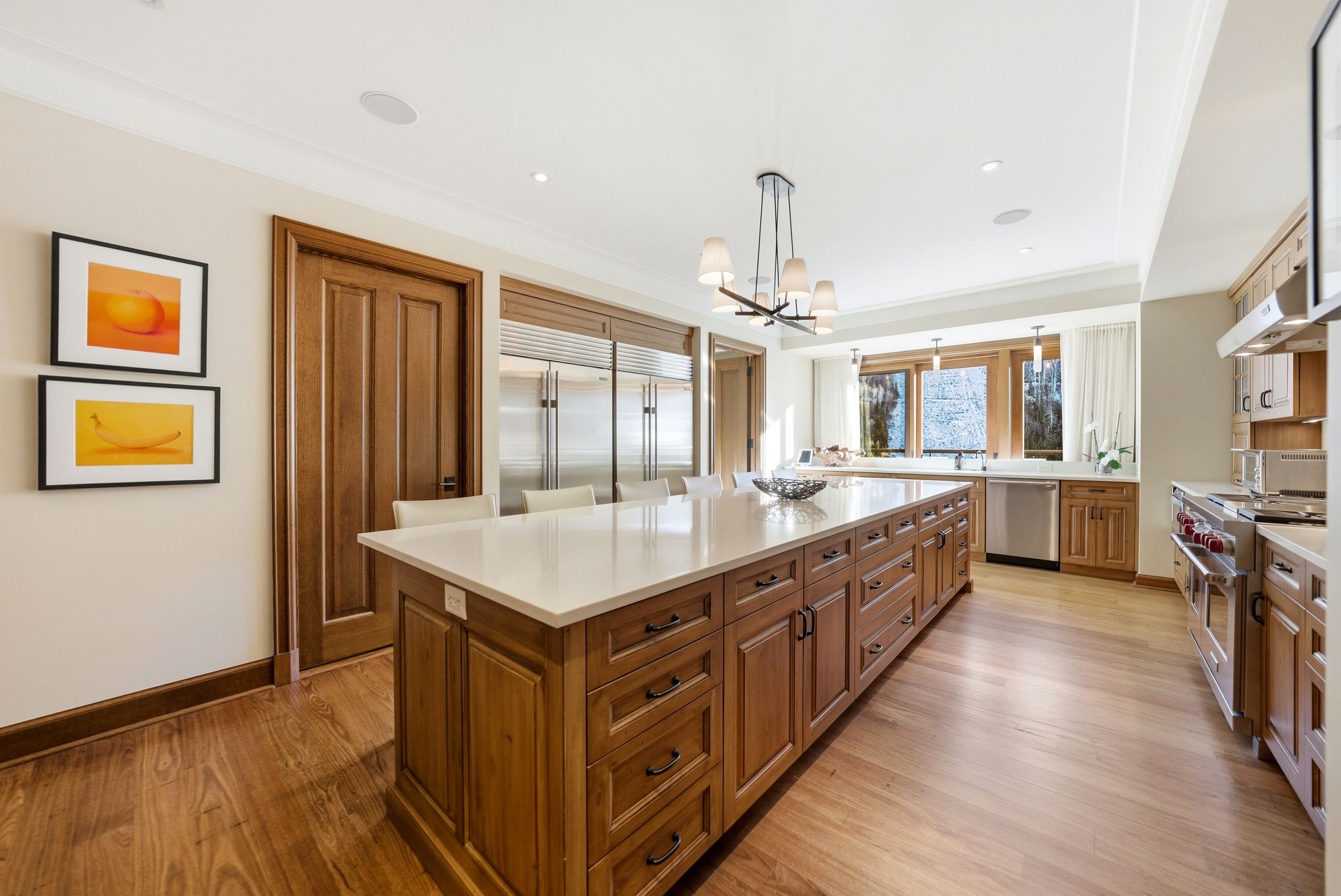 Kitchen with brown cabinetry, appliances with stainless steel finishes, light wood finished floors, and recessed lighting
